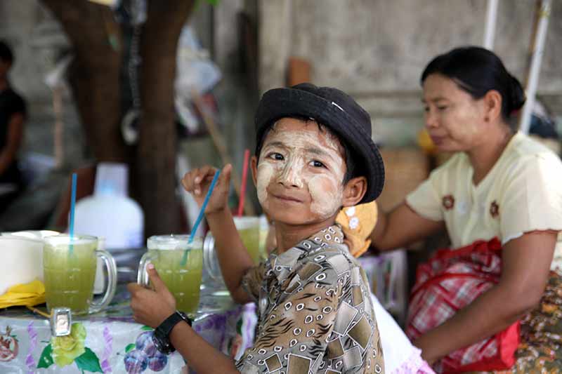 One of the first things that will catch your attention is many women and children (and sometimes guys) will have a white-yellow paste smeared on their faces. Thanaka is a white-yellow paste made from ground bark. Several trees are used to make this cosmetic paste and can found in the central area in central Myanmar. This facial covering has a long tradition in Myanmar, dating back over 2,000 years. The purpose of Thanaka is two-fold. Some of the women’s faces are covered in designs to enhance beauty. And others use the Thanaka to protect their skin. Fantastic Faces Of Myanmar. 